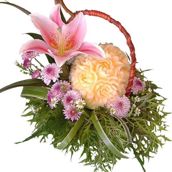Hand carved melon and Lily in basket of mixed blooms, close up