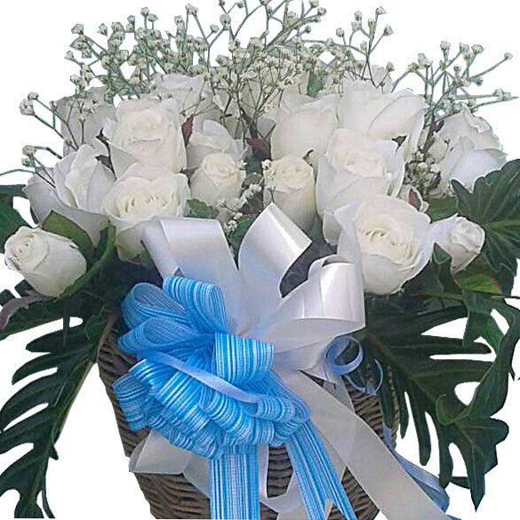 White Roses in a handmade wicker basket - close up